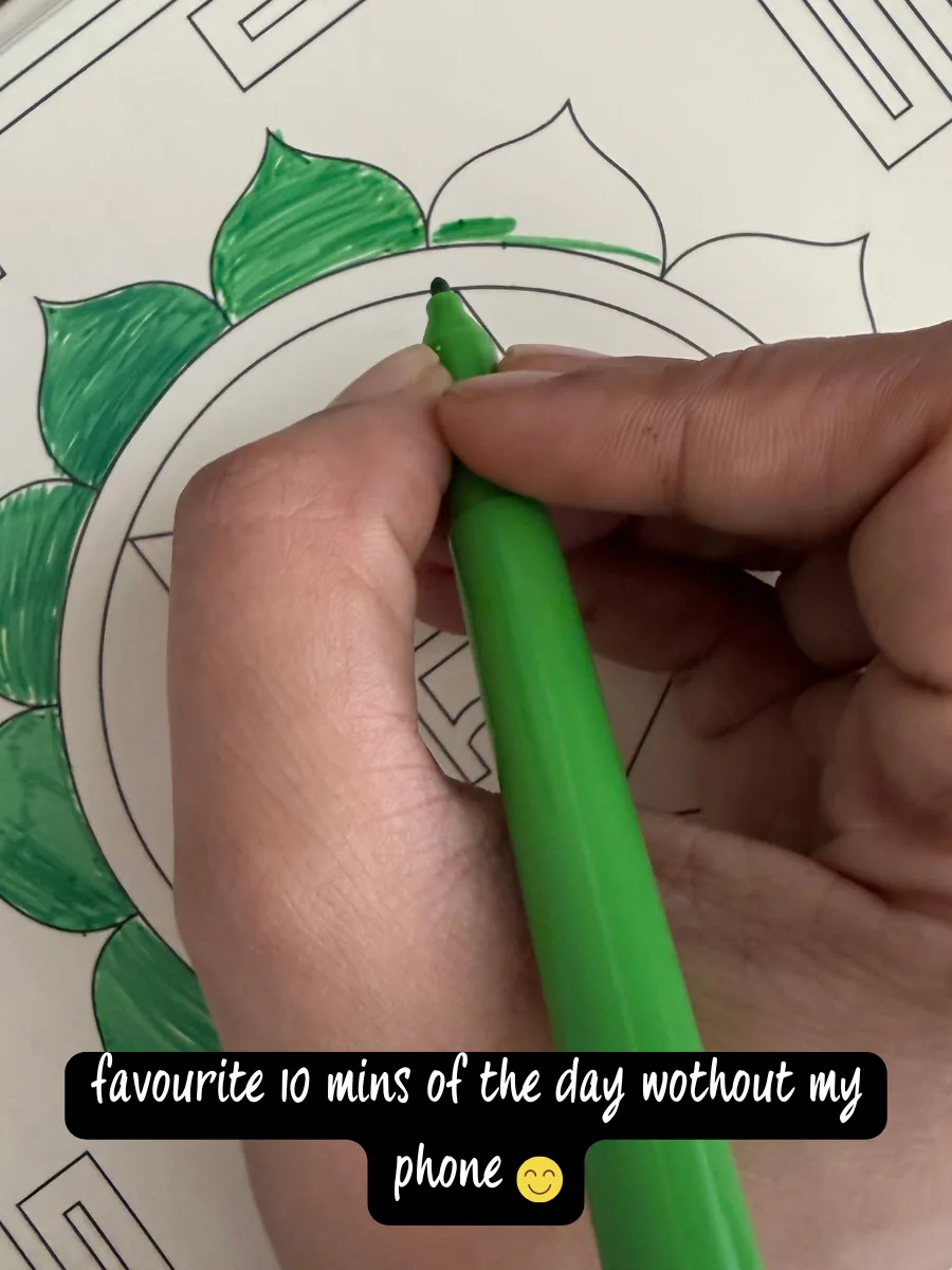 Mother colouring a chakra yantra in green, captioned "favourite 10 mins of the day without my phone"