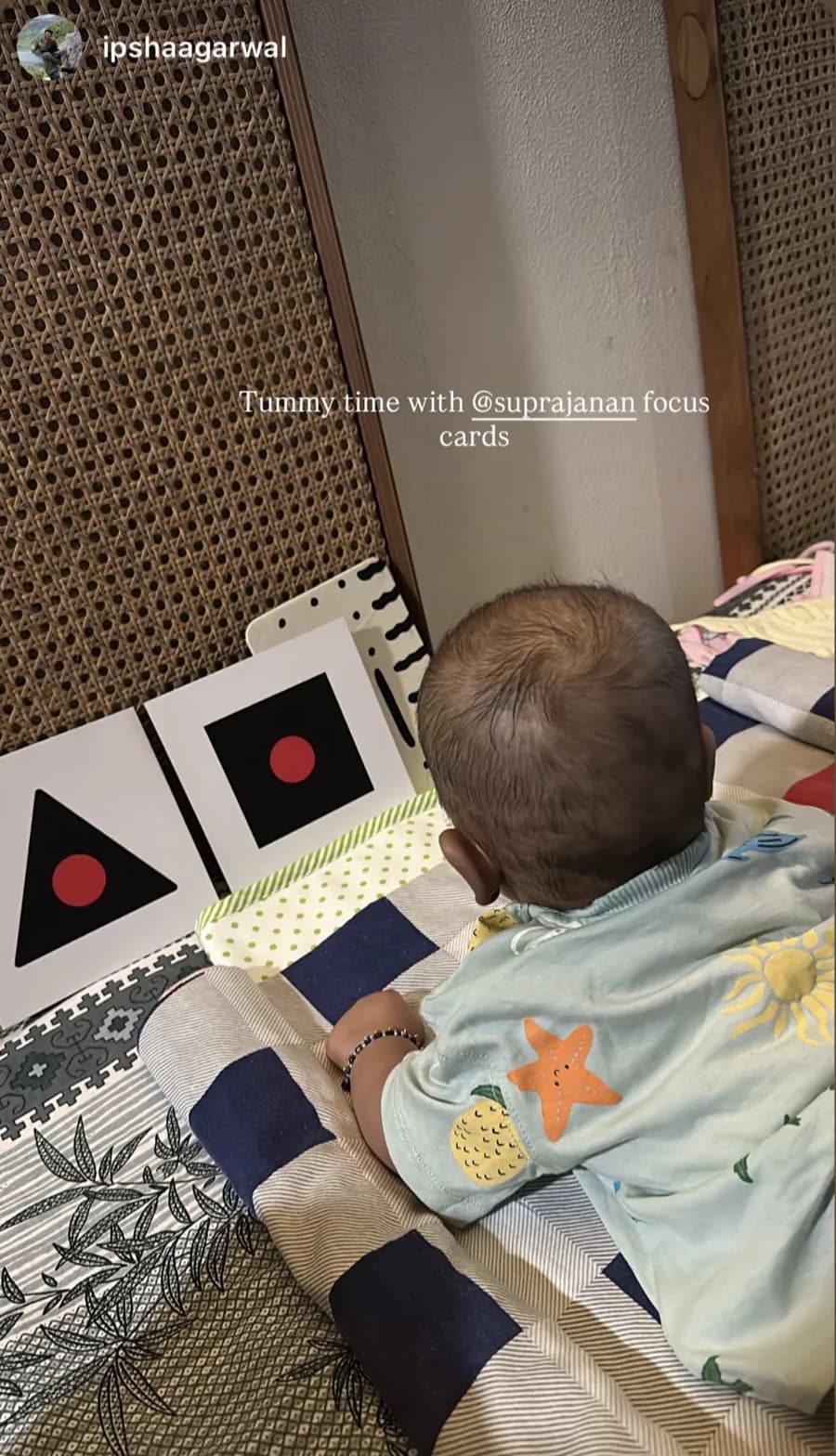 Baby during tummy time with Drishti focus cards propped in front