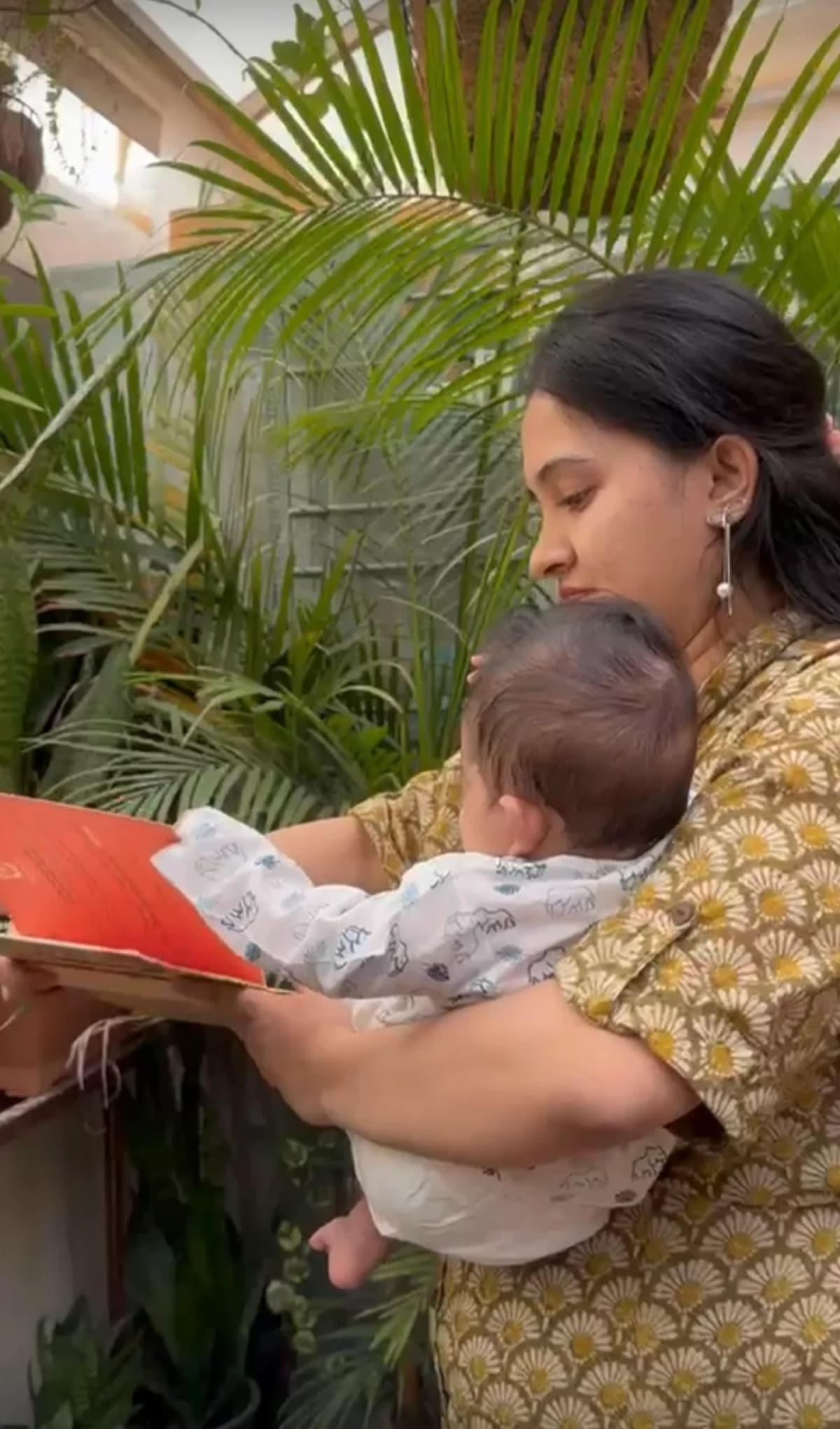 Mother reading to her newborn