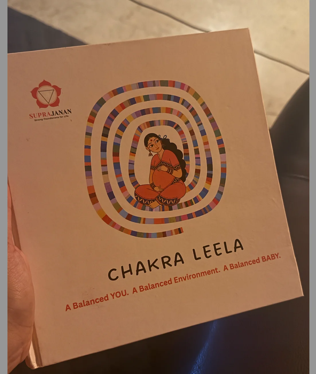 Chakra Leela held in a mother's hands